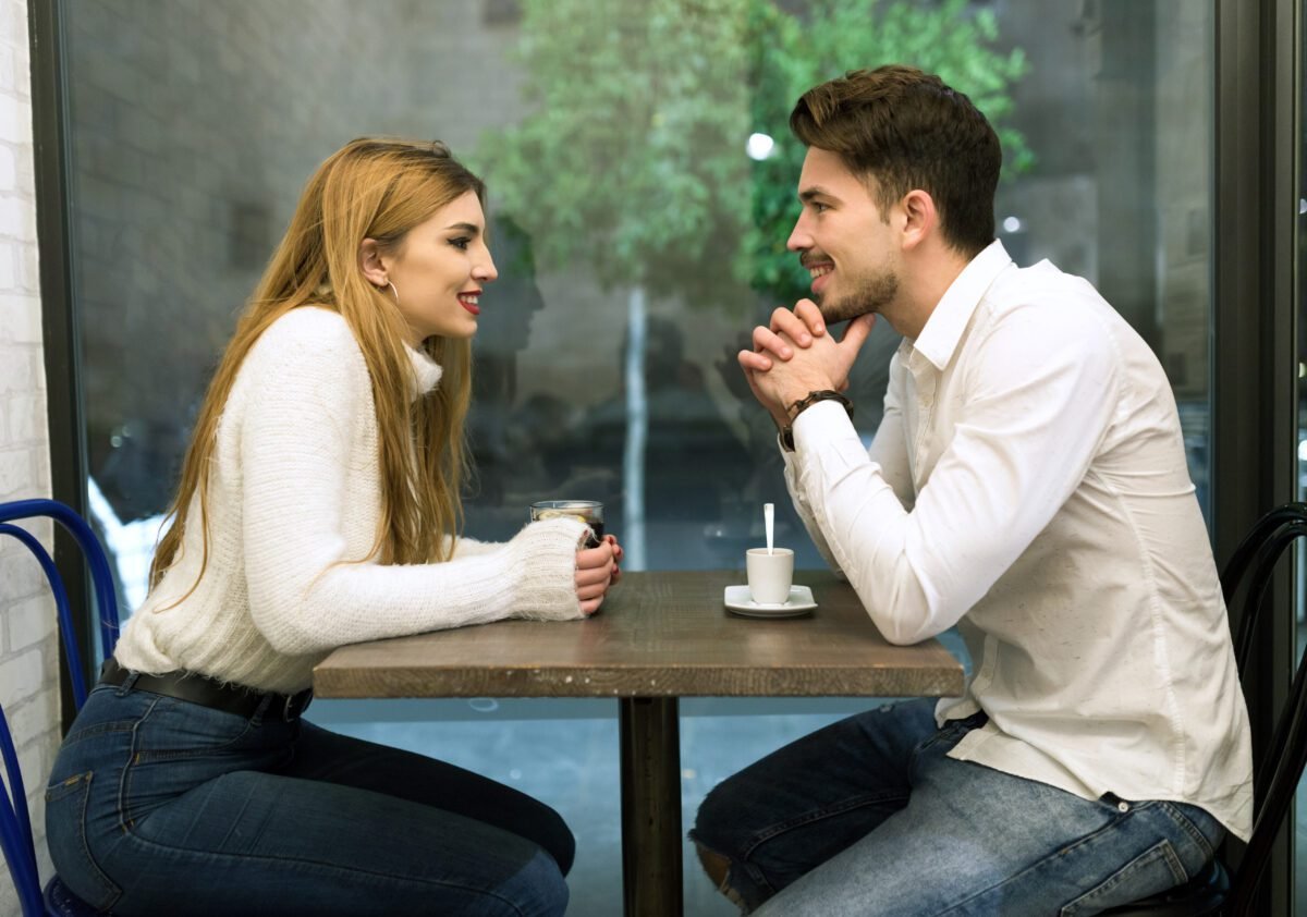 Beautiful young couple in love at a coffee shop.